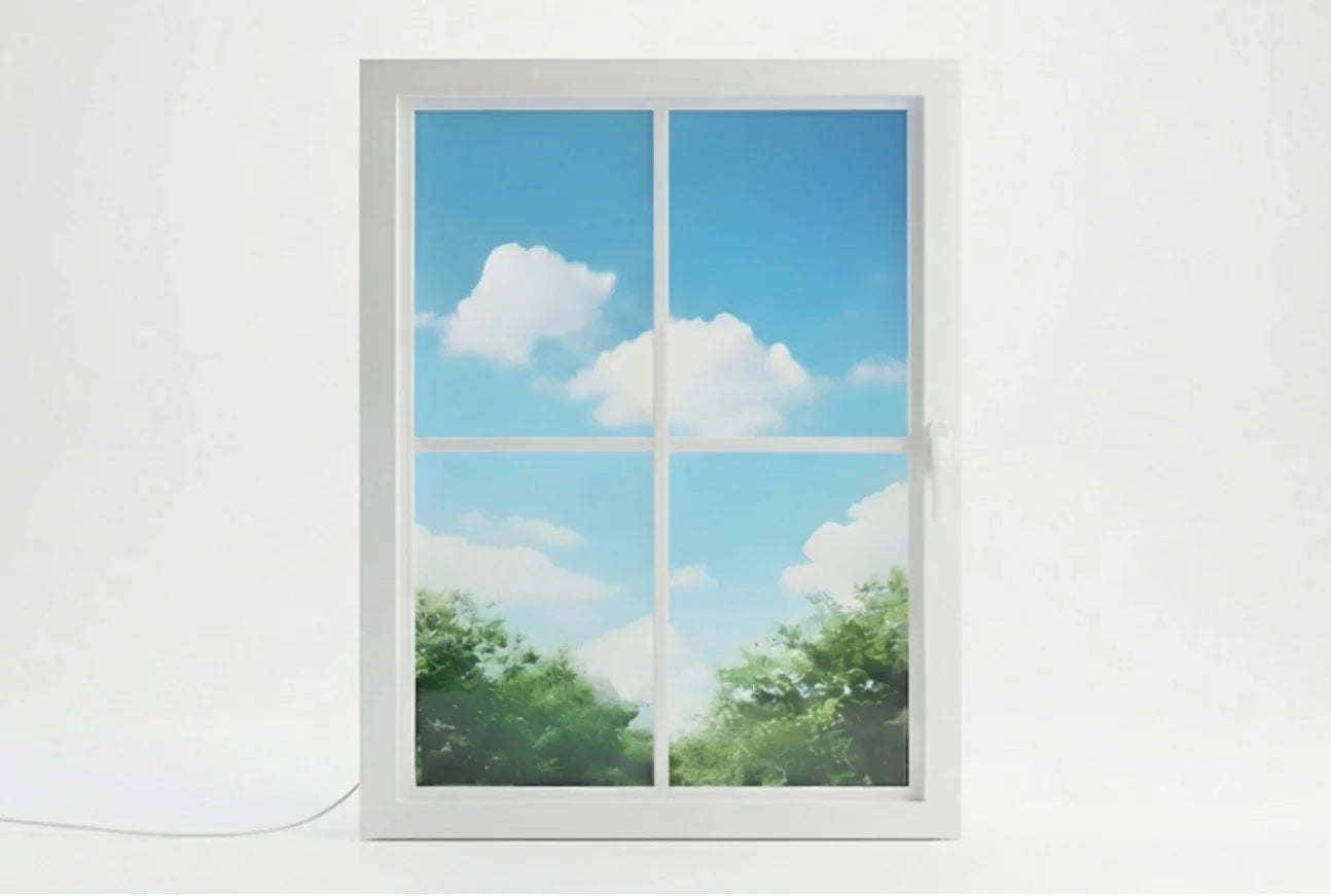 Vindow smart virtual window, white frame, showing blue sky, clouds, and greenery indoors