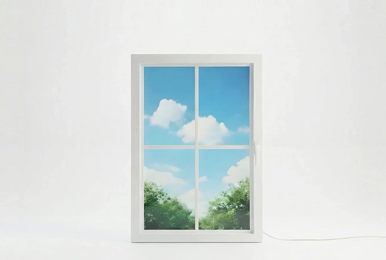 Vindow virtual window with white frame showing blue sky and clouds, simulating daylight indoors